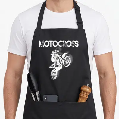 Tablier de cuisine noir avec inscription MOTOCROSS et silhouette blanche d'un motard en plein saut acrobatique.