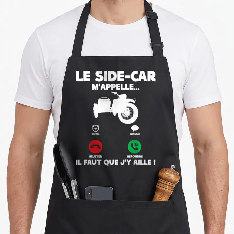 Tablier de cuisine noir avec silhouette blanche de moto à side-car et boutons d'appel téléphonique rouge et vert imprimés au centre.