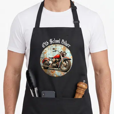 Tablier de cuisine noir avec illustration circulaire d'une moto vintage rouge et texte Old School Biker en typographie gothique blanche.