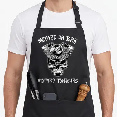 Tablier de cuisine noir avec moteur V2 et tête de mort illustrée en blanc au centre.