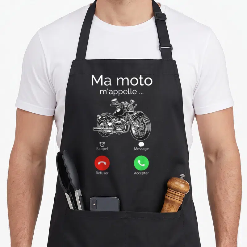Tablier de cuisine noir avec illustration d'un téléphone affichant Ma moto m'appelle et des boutons d'appel.