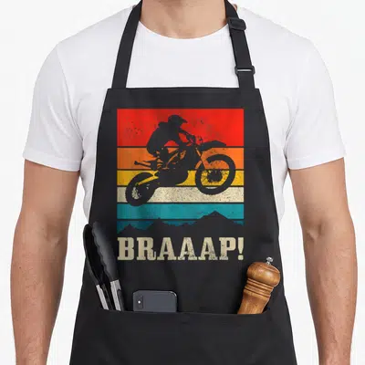 Tablier de cuisine noir avec silhouette de moto Enduro sur bandes colorées et texte Braaap.