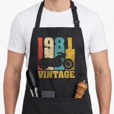 Tablier de cuisine noir avec motif 1981 Vintage et silhouettes de motos vintage multicolores.