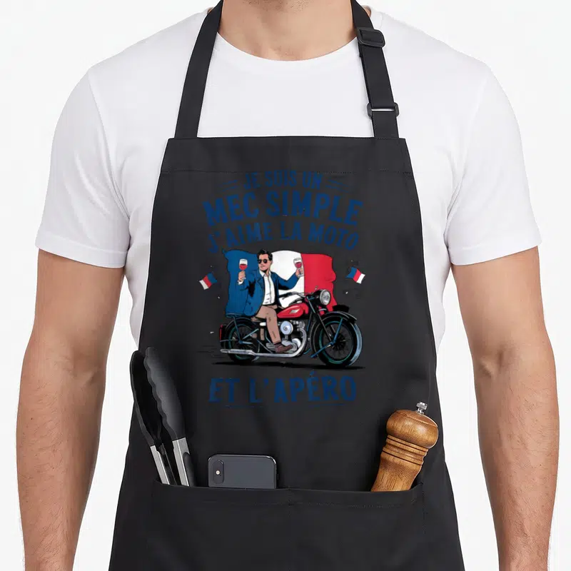 Tablier de cuisine noir avec illustration motard tenant deux verres de vin devant un drapeau français.