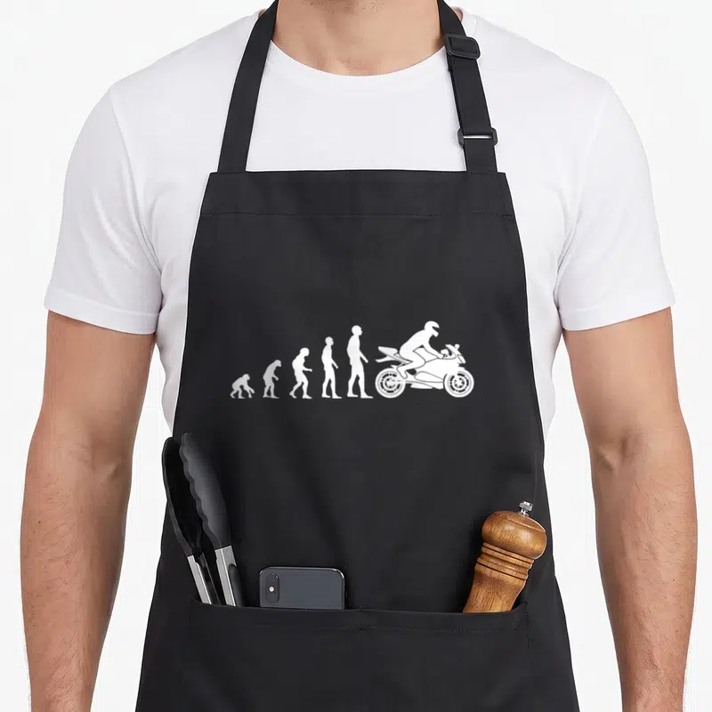 Tablier de cuisine noir avec silhouettes blanches montrant l'évolution humaine vers un motard sur moto sport.