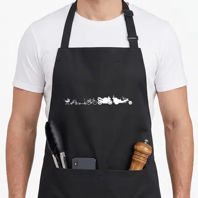 Tablier de cuisine noir avec silhouette blanche évoluant d'une poussette à une moto chopper sur fond uni.