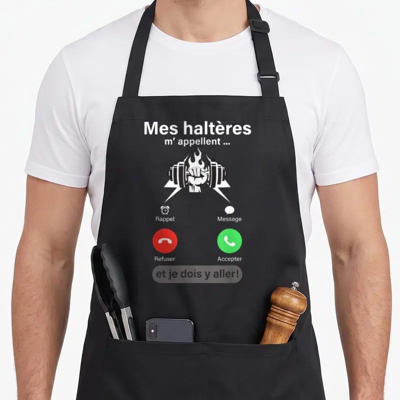 Tablier de cuisine noir avec illustration d'une main tenant un haltère en feu et texte humoristique sur appel téléphonique.