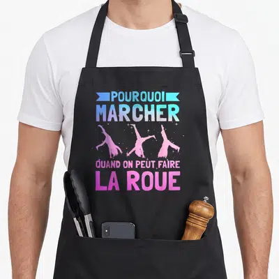 Tablier de cuisine noir avec silhouettes gymniques roses et texte Pourquoi marcher faire la roue en dégradé bleu et violet.