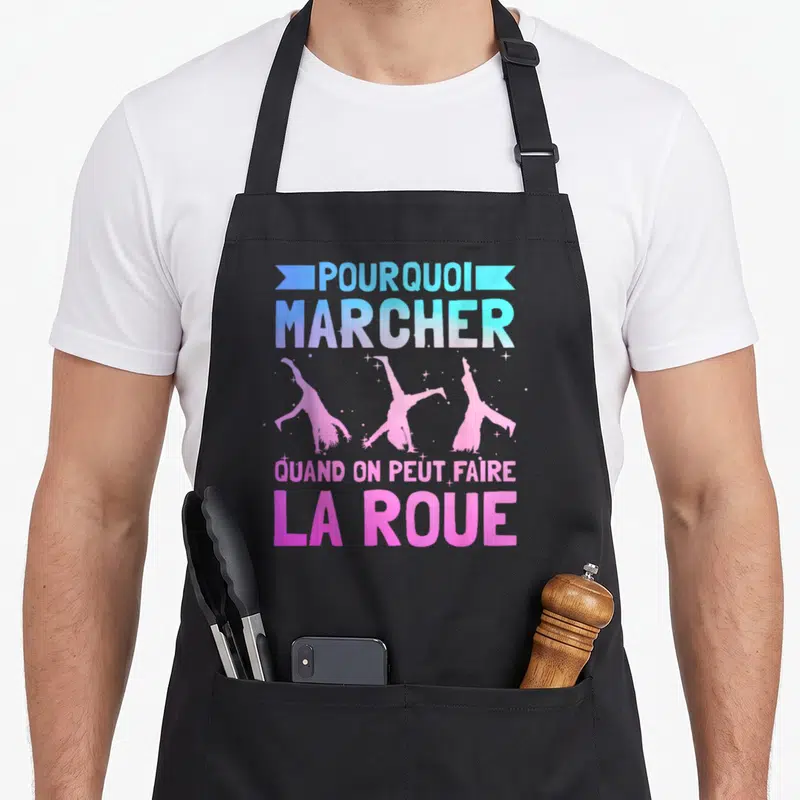 Tablier de cuisine noir avec silhouettes gymniques roses et texte Pourquoi marcher faire la roue en dégradé bleu et violet.