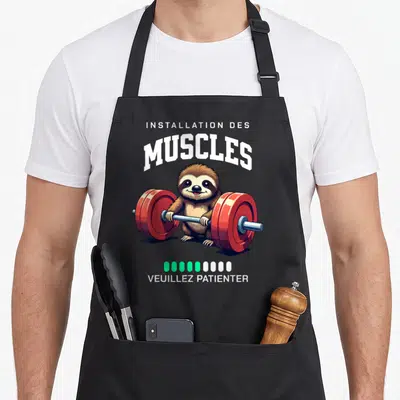 Tablier de cuisine noir avec un fourreau tenant une barre de poids rouge et le texte Installation des muscles.