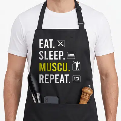 Tablier de cuisine noir avec l'inscription Eat Sleep Muscu Repeat et des icônes blanches et jaunes.