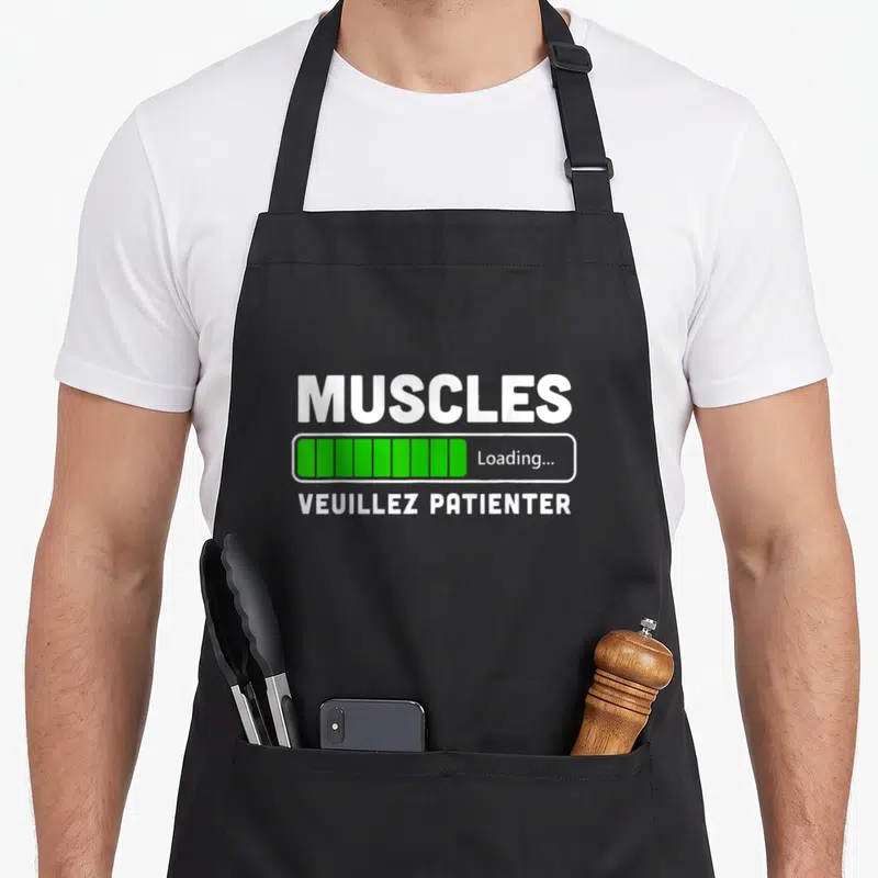 Tablier de cuisine noir avec une barre de chargement verte et le texte Muscles Loading Veuillez patienter en blanc.