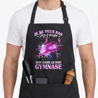 Tablier de cuisine noir avec des silhouettes de gymnastes roses et le texte Je ne peux pas dans le gymnase.