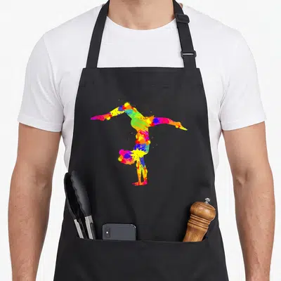 Tablier de cuisine noir avec une silhouette de gymnaste réalisée en éclaboussures de peinture multicolore vive.