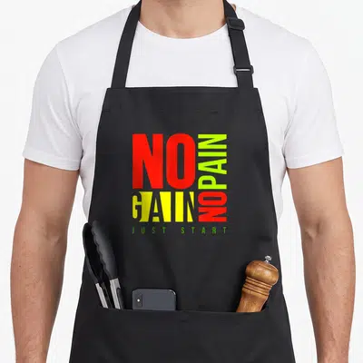 Tablier de cuisine noir avec l'inscription No Pain No Gain en rouge et jaune, et Just Start en vert.