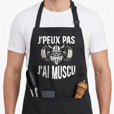 Tablier de cuisine noir avec illustration d'un viking tenant une barre de poids et texte blanc J'peux pas j'ai muscu