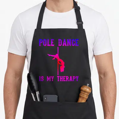 Tablier de cuisine noir avec une silhouette rose sur perche et le texte Pole Dance is my therapy en violet et magenta.