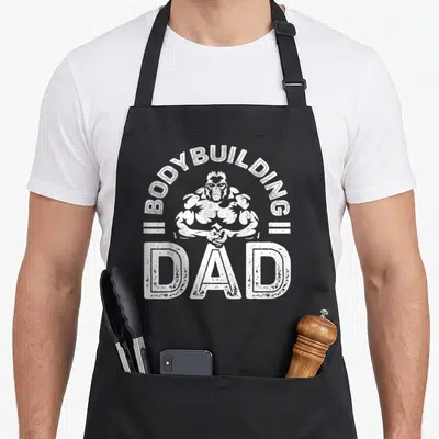 Tablier de cuisine noir avec illustration d'un gorille musclé et texte Bodybuilding Dad en blanc.
