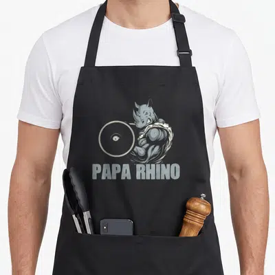 Tablier de cuisine noir avec illustration d'un papa rhinocéros musclé soulevant une barre et le texte Papa Rhino.