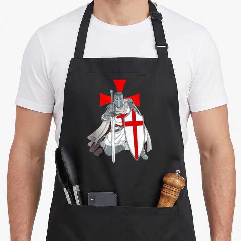 Tablier de cuisine noir avec illustration d'un chevalier templier en armure tenant un bouclier blanc à croix rouge et une épée.