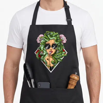 Tablier de cuisine noir avec une Méduse hippie aux serpents verts et roses roses.