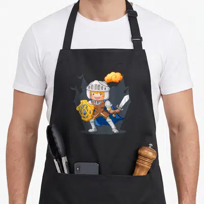 Tablier de cuisine noir avec illustration d'un jeune chevalier souriant tenant un bouclier et une épée devant un château.
