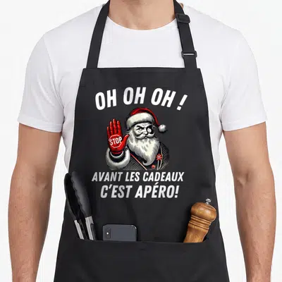 Tablier de cuisine noir avec illustration d'un Père Noël tenant un panneau Stop rouge et du texte humoristique en blanc.