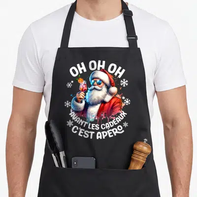 Tablier de cuisine noir avec un Père Noël en lunettes de soleil tenant un cocktail coloré.