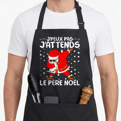 Tablier de cuisine noir avec un Père Noël en train de faire le dab et des lunettes de soleil.