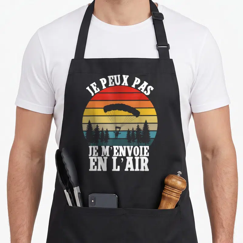 Tablier de cuisine noir avec illustration vintage d'un parapente et texte blanc Je peux pas je m'envoie en l'air.
