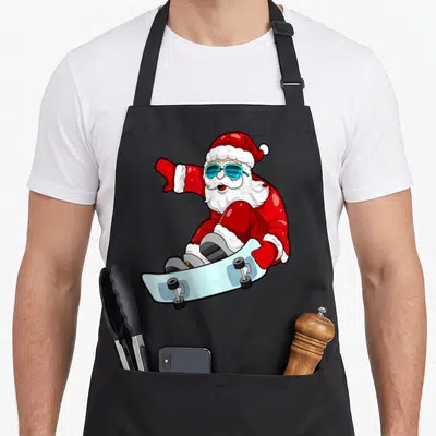 Tablier de cuisine noir avec illustration d'un Père Noël sur planche à roulettes et lunettes de soleil bleues.