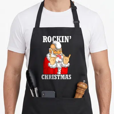 Tablier de cuisine noir avec illustration d'un Père Noël rock effectuant le signe des cornes en rouge et blanc.