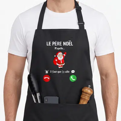 Tablier de cuisine noir avec illustration d'un père Noël levant la main et des boutons d'appel téléphonique rouge et vert.