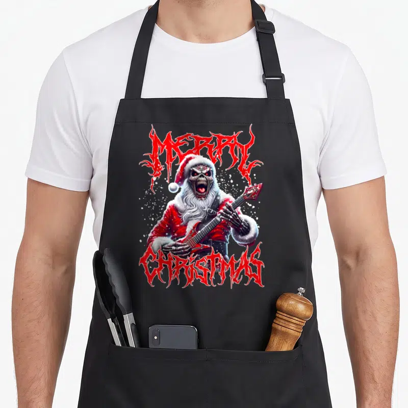 Tablier de cuisine noir avec un Père Noël squelette jouant de la guitare et du texte Merry Christmas en style heavy metal.