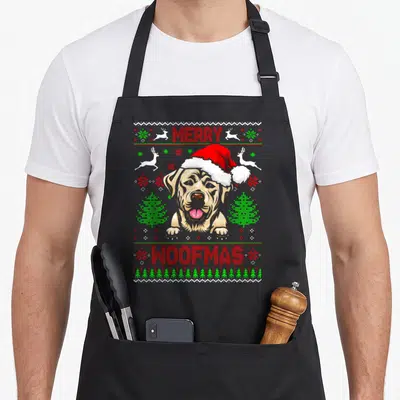 Tablier de cuisine noir avec illustration labrador chapeau Père Noël et texte Merry Woofmas.