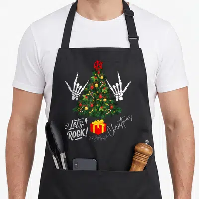 Tablier de cuisine noir avec sapin de Noël punk orné de mains en os et texte Let's Rock Christmas.