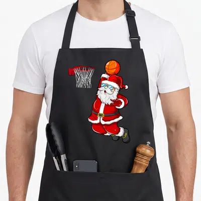 Tablier de cuisine noir avec illustration d'un Père Noël basketball portant des lunettes.