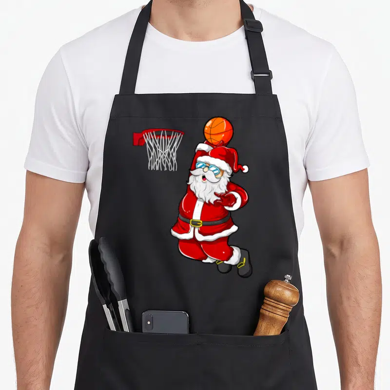 Tablier de cuisine noir avec illustration d'un Père Noël basketball portant des lunettes.