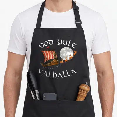 Tablier de cuisine noir avec illustration d'un bateau viking, de rennes et texte God Yule Valhalla.