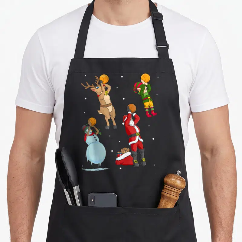 Tablier de cuisine noir avec Santa, renne, elfe et bonhomme de neige jouant au basket-ball.