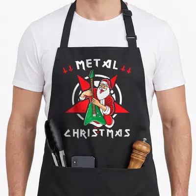 Tablier de cuisine noir avec un Père Noël jouant d'une guitare verte et les mots METAL CHRISTMAS en blanc.