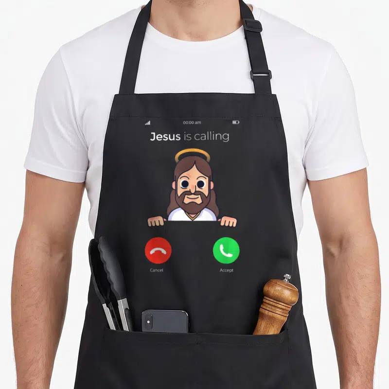 Tablier de cuisine noir avec illustration d'un appel de Jésus et boutons verts et rouges.