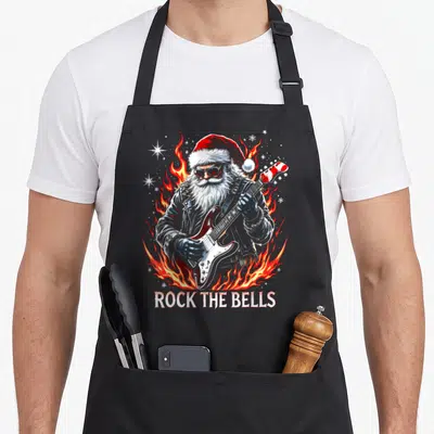 Tablier de cuisine noir avec illustration d'un Père Noël guitariste entouré de flammes et du texte Rock The Bells.
