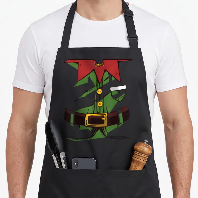Tablier de cuisine noir avec illustration d'un costume de lutin vert à col rouge et ceinture marron à boucle dorée.