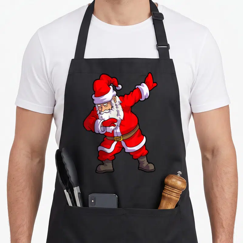 Tablier de cuisine noir avec un Père Noël rouge effectuant la pose du dab.