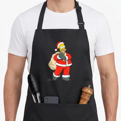 Tablier de cuisine noir avec Homer Simpson en costume de Père Noël rouge portant un sac beige et une cloche dorée.