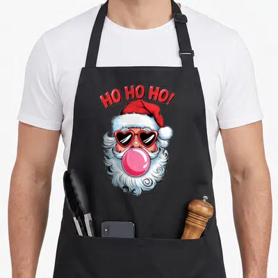 Tablier de cuisine noir avec Père Noël lunettes cœur crachant une bulle rose et texte Ho Ho Ho.