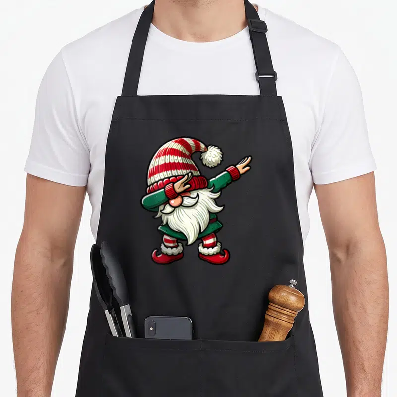 Tablier de cuisine noir avec illustration colorée d'un nain effectuant une pose dab festive.
