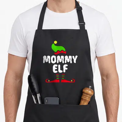 Tablier de cuisine noir avec inscription Mommy Elf Mommy, bonnet vert et bottes rouges d'elfe.
