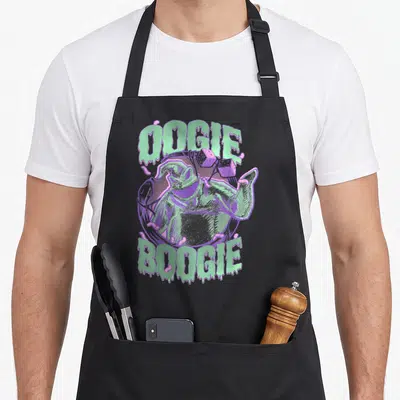 Tablier de cuisine noir avec portrait coloré d'Oogie Boogie et texte vert dégoulinant.